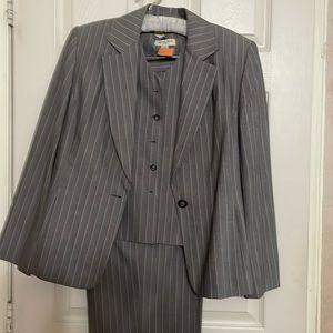 Three piece gray striped pants suit.